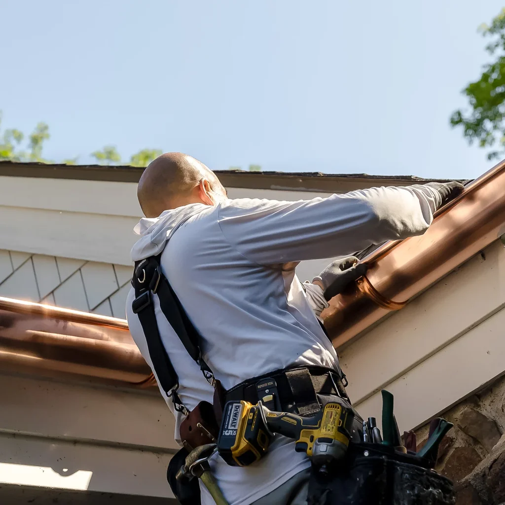 Sheridan Sheet Metal team installing gutters